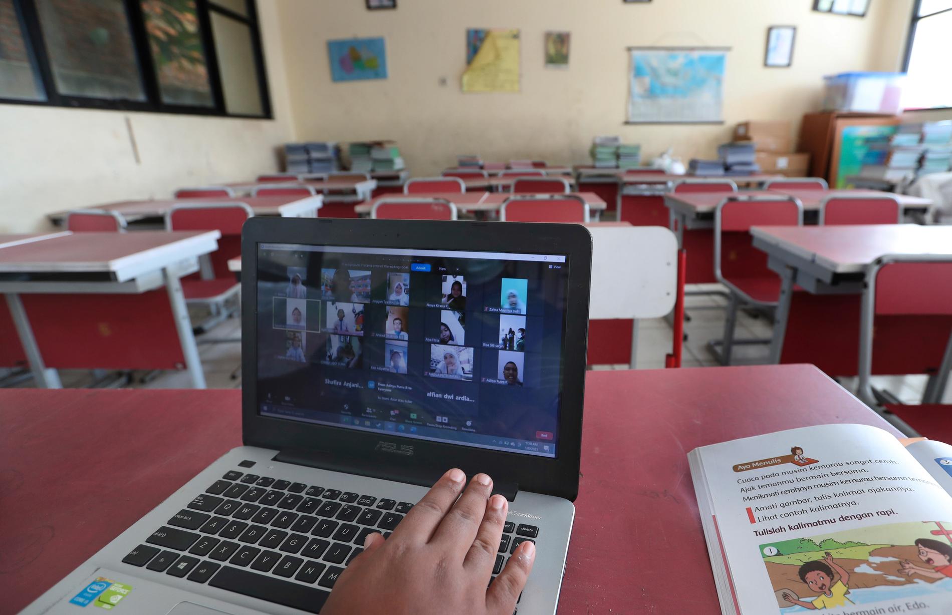 En lärare på en grundskola i Indonesien använder sin dator till att distansundervisa elever. Bilden är från i början av januari.