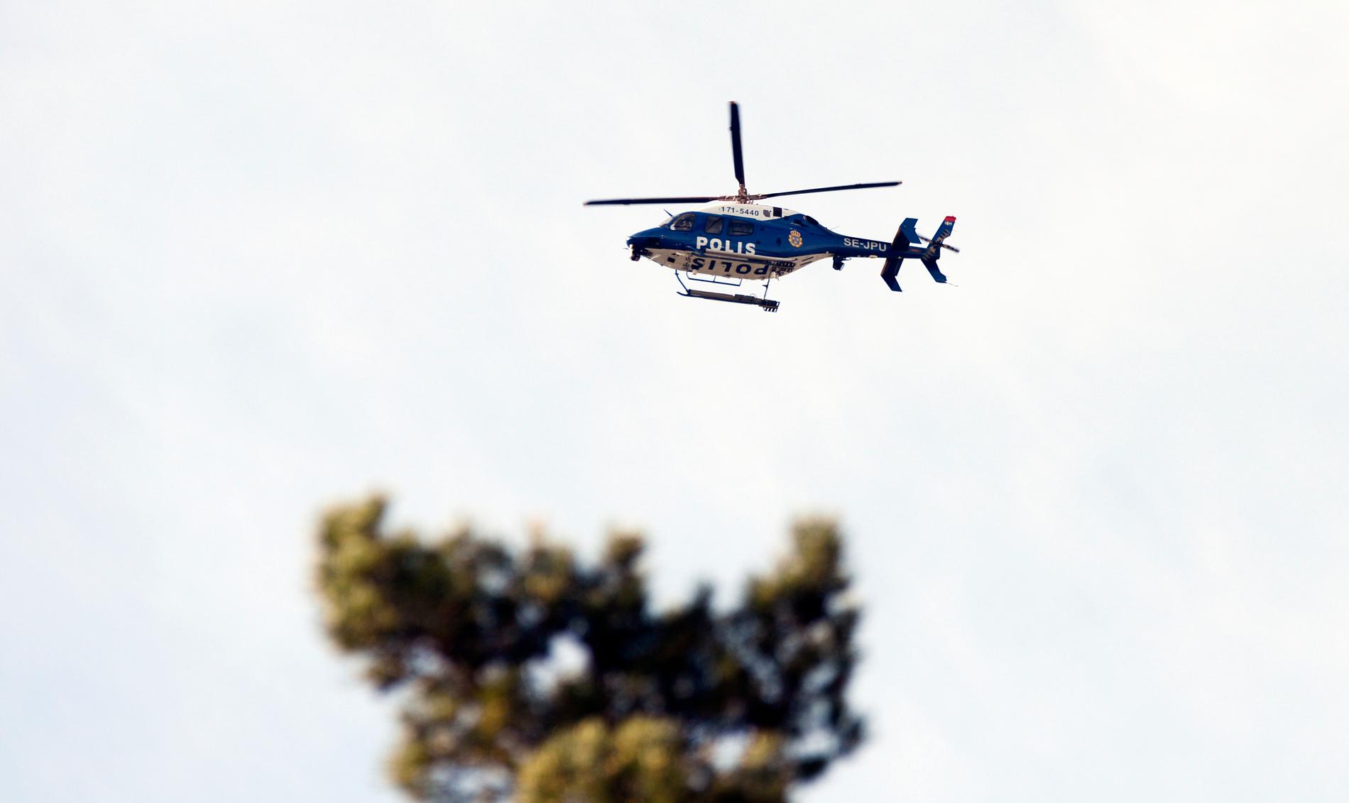 Polisen har kallat en helikopter till Märsta efter att en kvinna hittats död nära en skola.