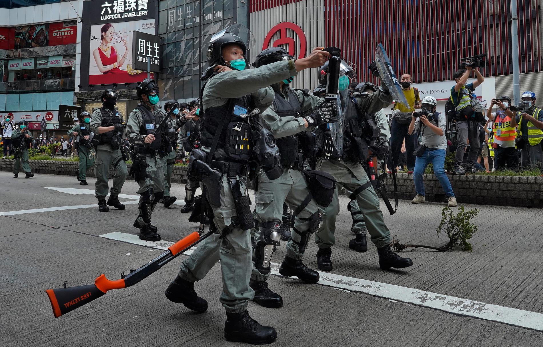 Kravallpolis på gatorna i Hongkong under söndagens demonstrationer.