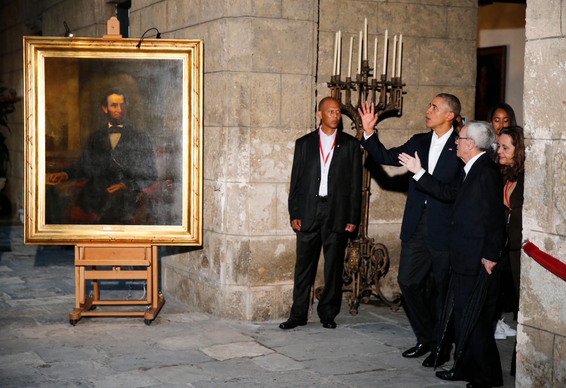 Barack Obama guidas runt i  gamla stan i Havanna. Här vid ett porträtt av Abraham Lincoln