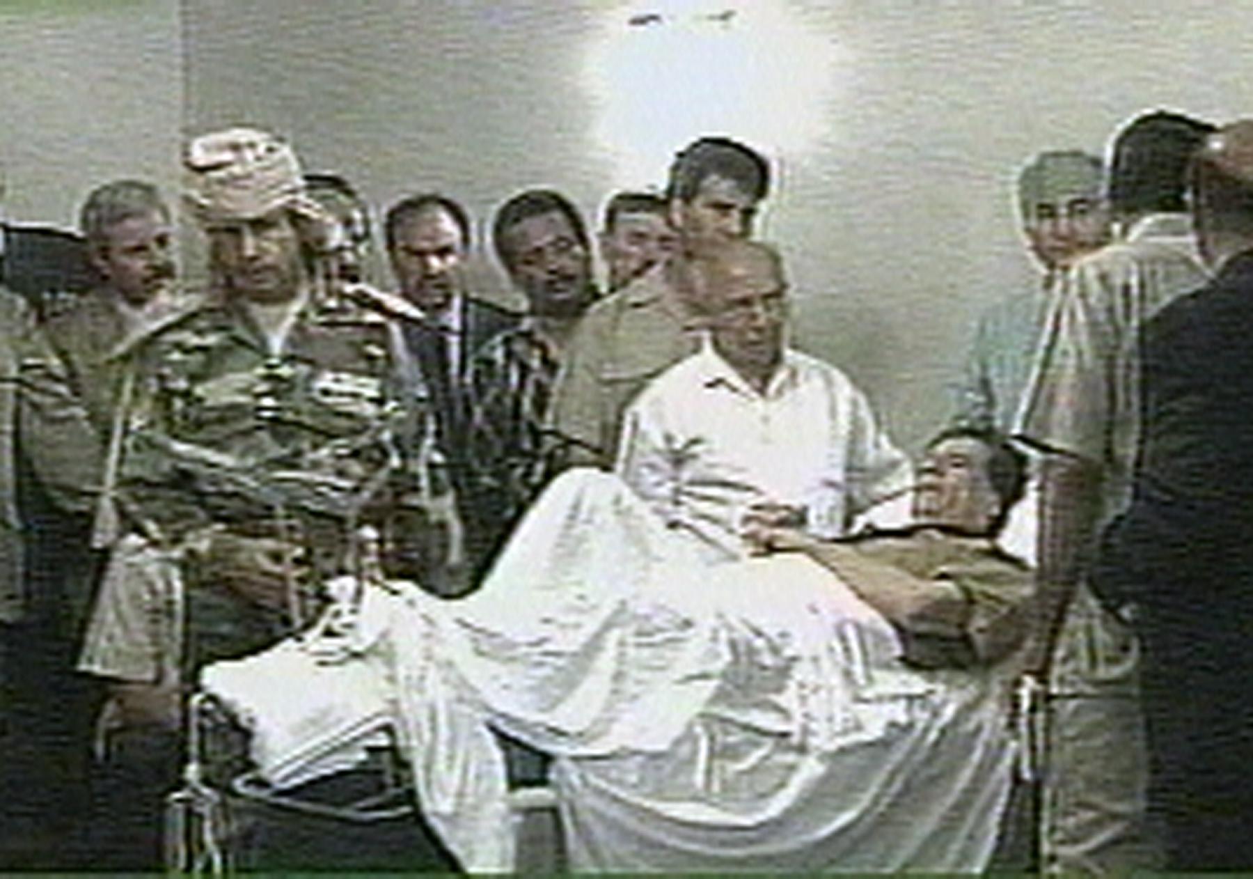 En höftfraktur stoppade inte Gaddafi 1996. Här tar han emot dignitärer från sjuksängen.