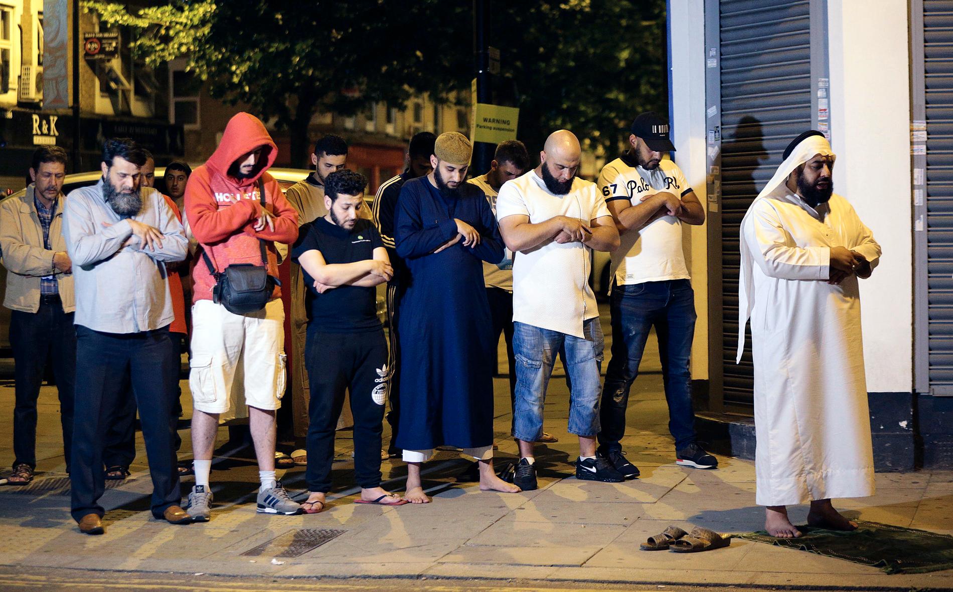 Människor ber utanför moskén i London efter den förmodade terrorattacken.