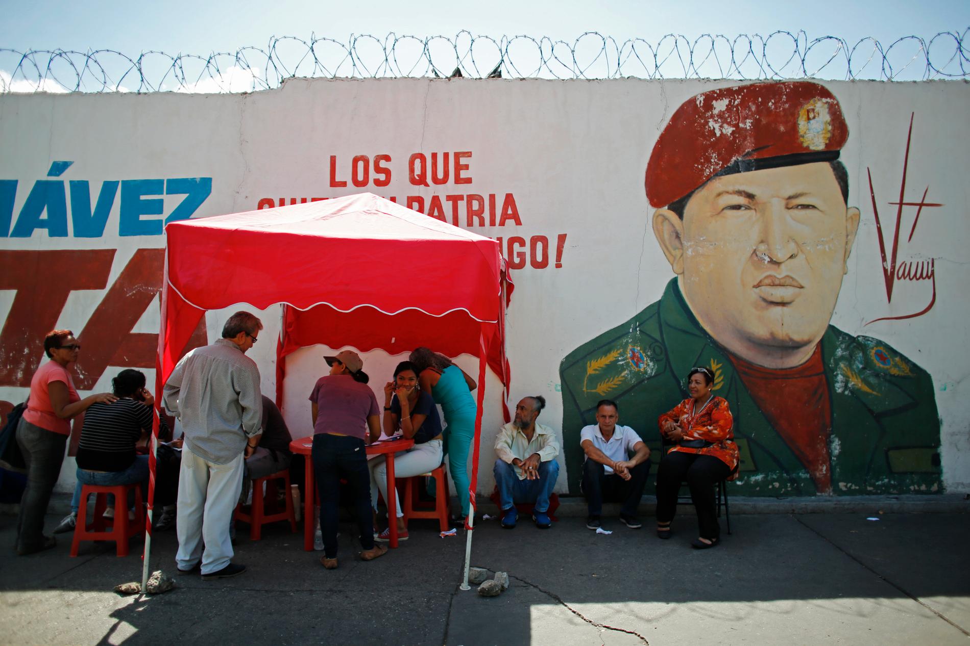 En av de så kallade röda punkterna vid en vallokal i Caracas, framför en bild på Hugo Chávez.