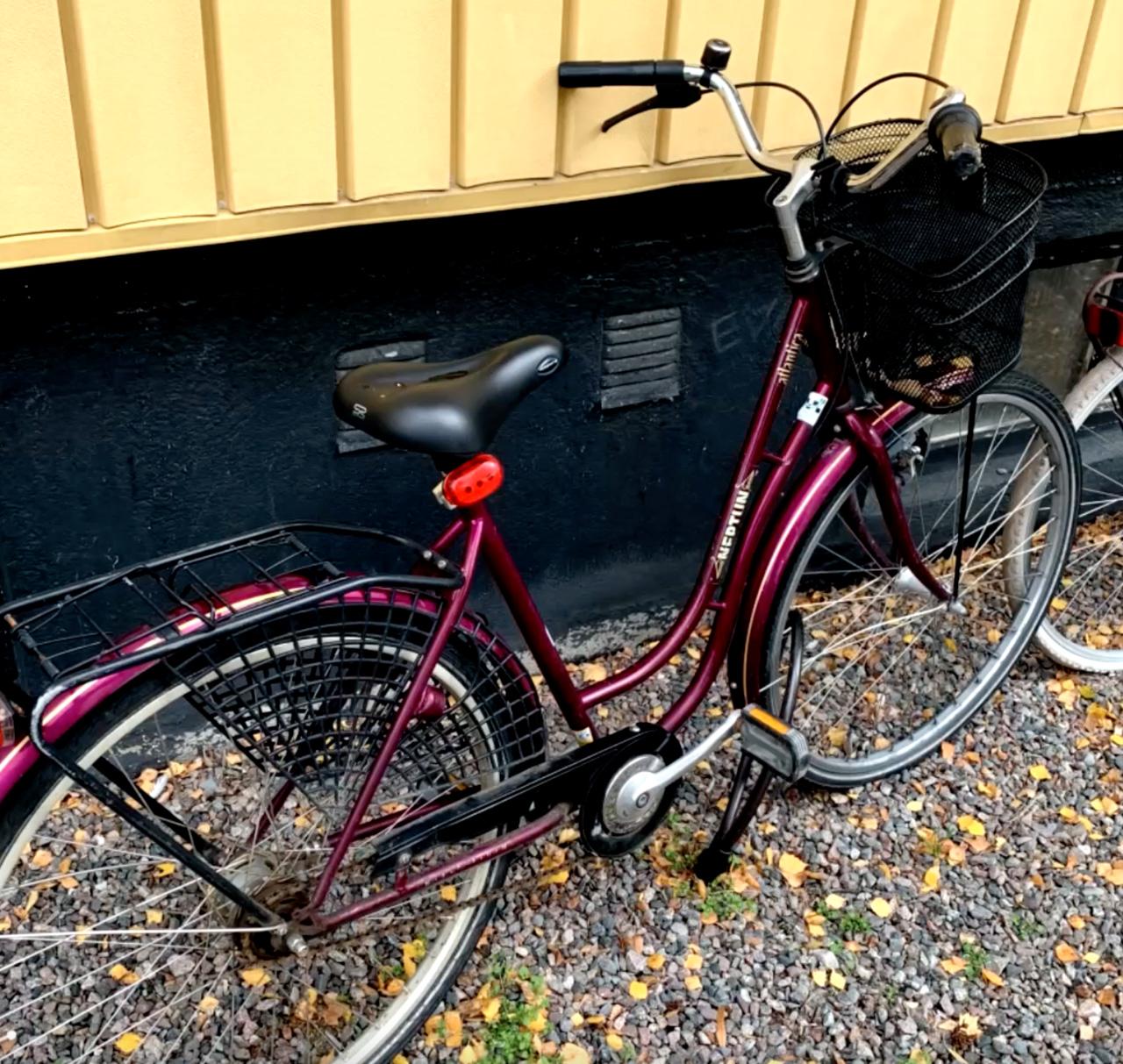 Toves cykel – låst och placerad mot en husvägg. 
