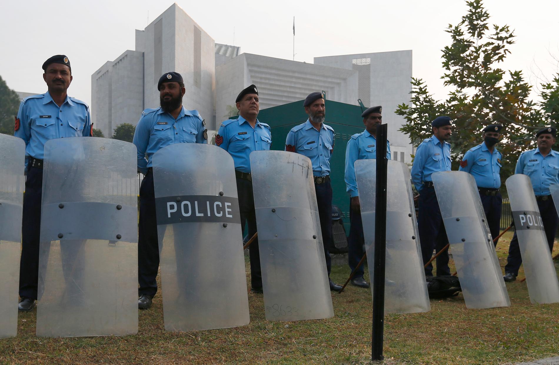 Poliser utanför högsta domstolen i Pakistan inför beslutet.