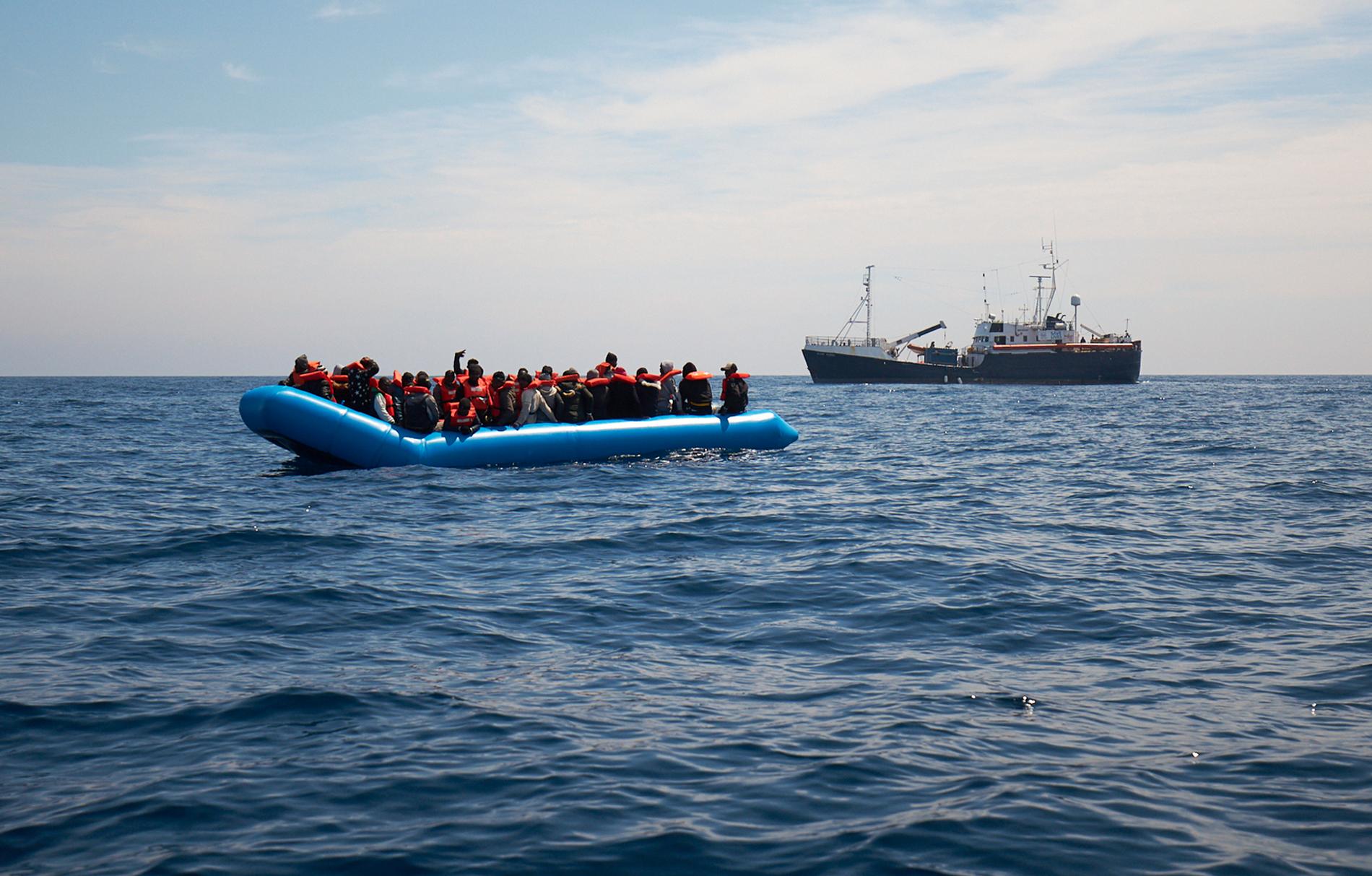 En fullastad gummibåt med migranter undsätts av det tyska fartyget Sea-eye, ett av de få räddningsfartyg som fortfarande patrullerar vattnen mellan Libyen och Italien. Bilden är tagen i april.