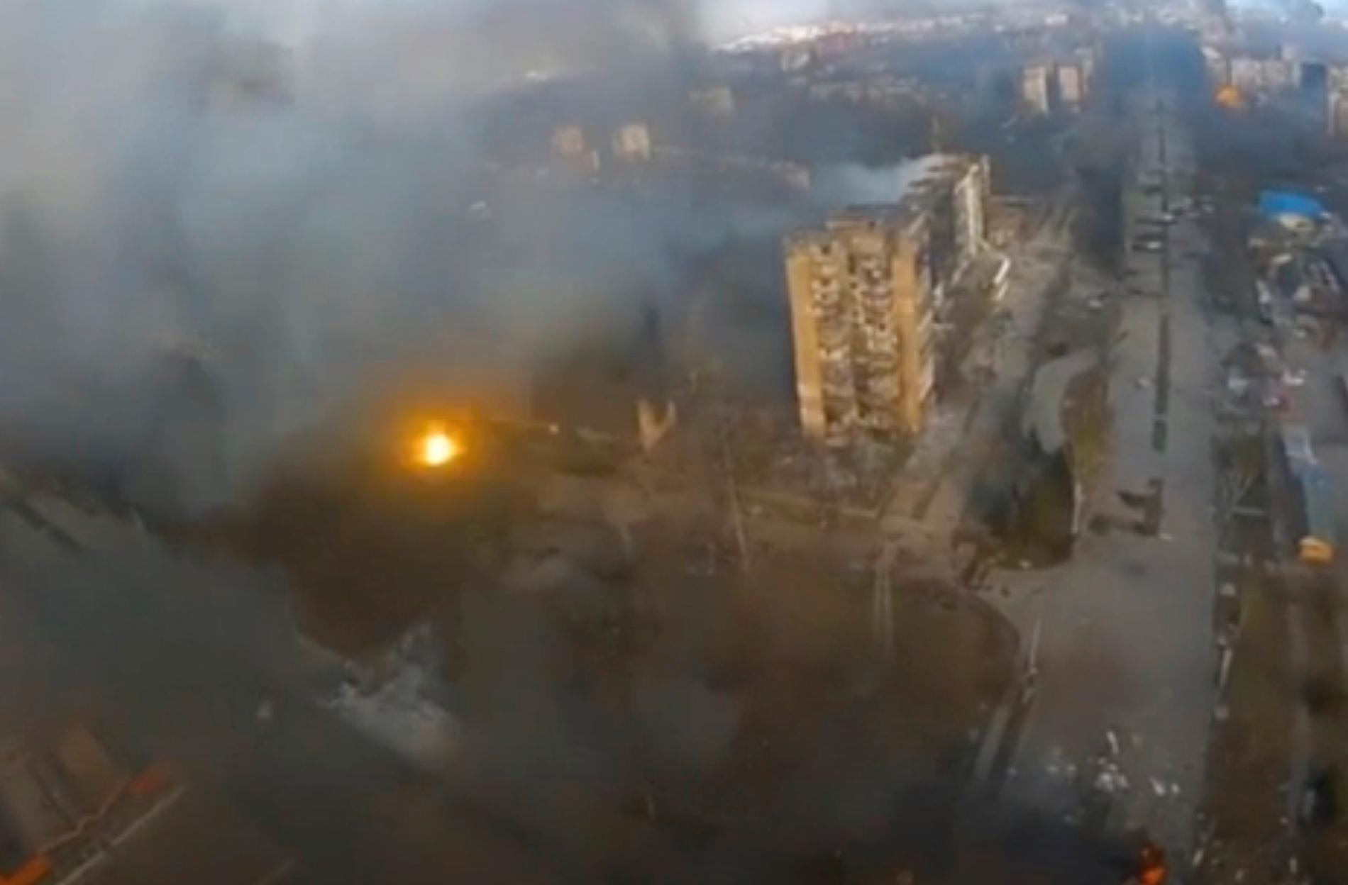 En explosion, och mörk rök stiger upp från flera byggnader i Mariupol. Bilden är från en video tagen i måndags. Staden, som ligger vid Azovsjön, är omringad av ryska styrkor och har utsatts för kraftigt bombardemang senaste veckan.