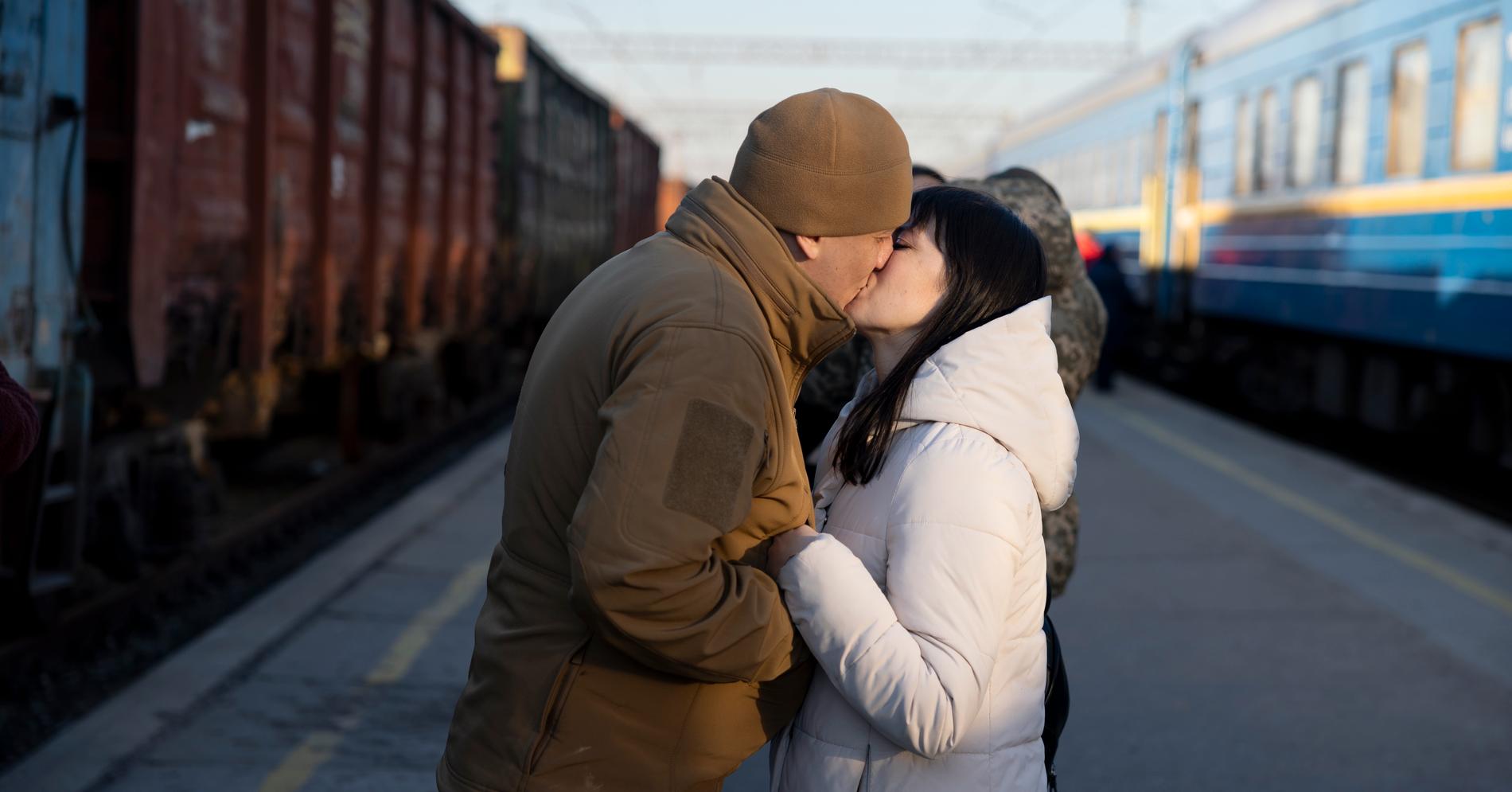 Soldaten Jevhen och hans fru Zoriana kysser varandra på tågstationen i Kramatorsk. 