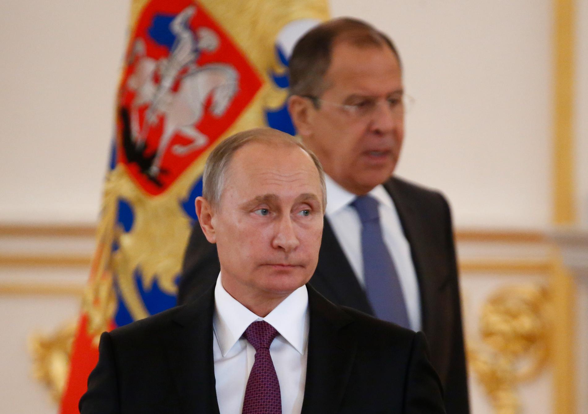 Rysslands president Vladimir Putin med utrikesminister Sergei Lavrov i bakgrunden. 
