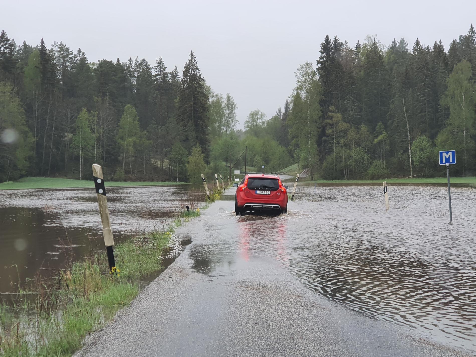 En bilist i Åkersberga stod stilla mitt på vägen, förmodligen i väntan på att vattenmassorna skulle sjunka undan.