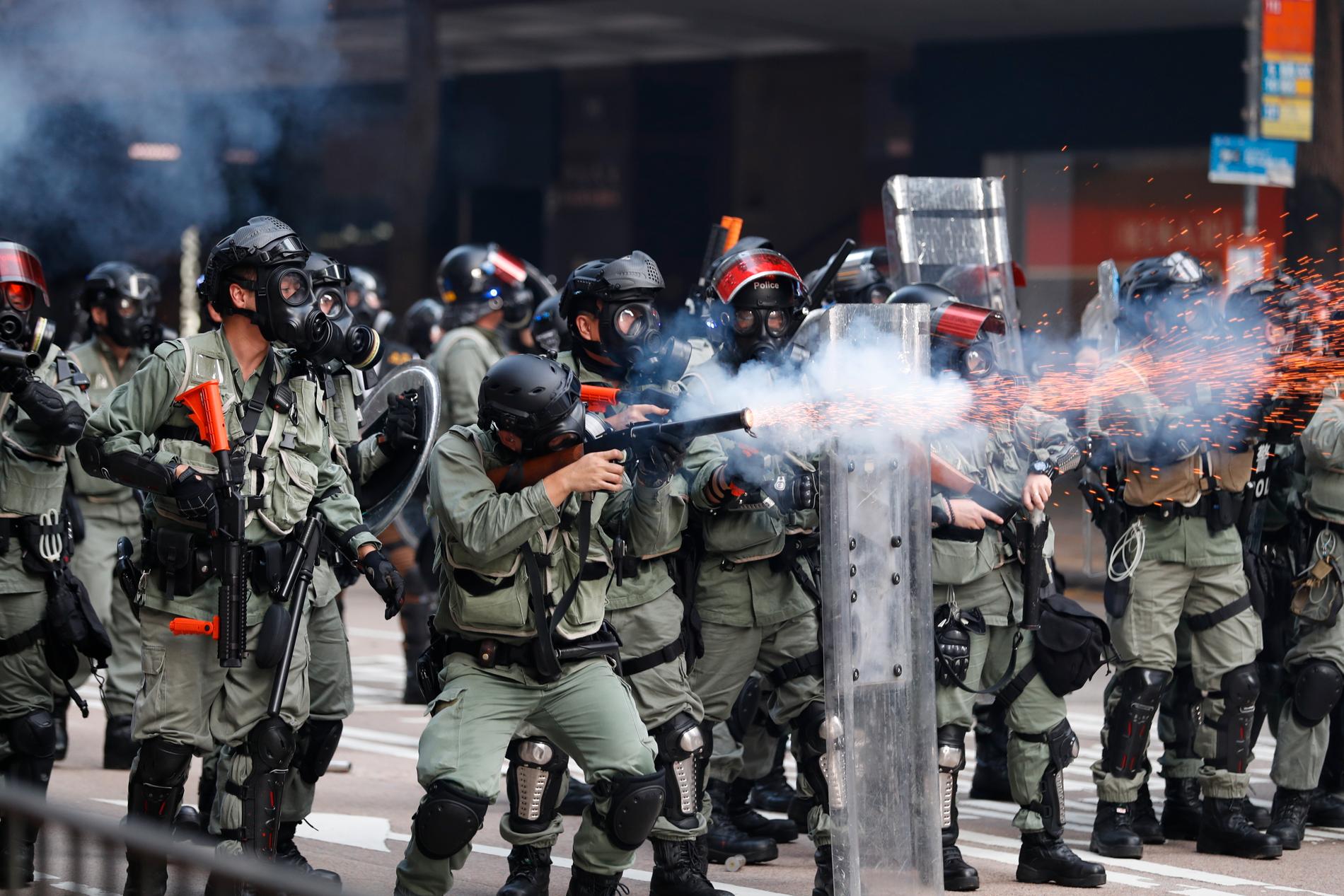 Polisen avfyrar tårgas mot demonstranterna.