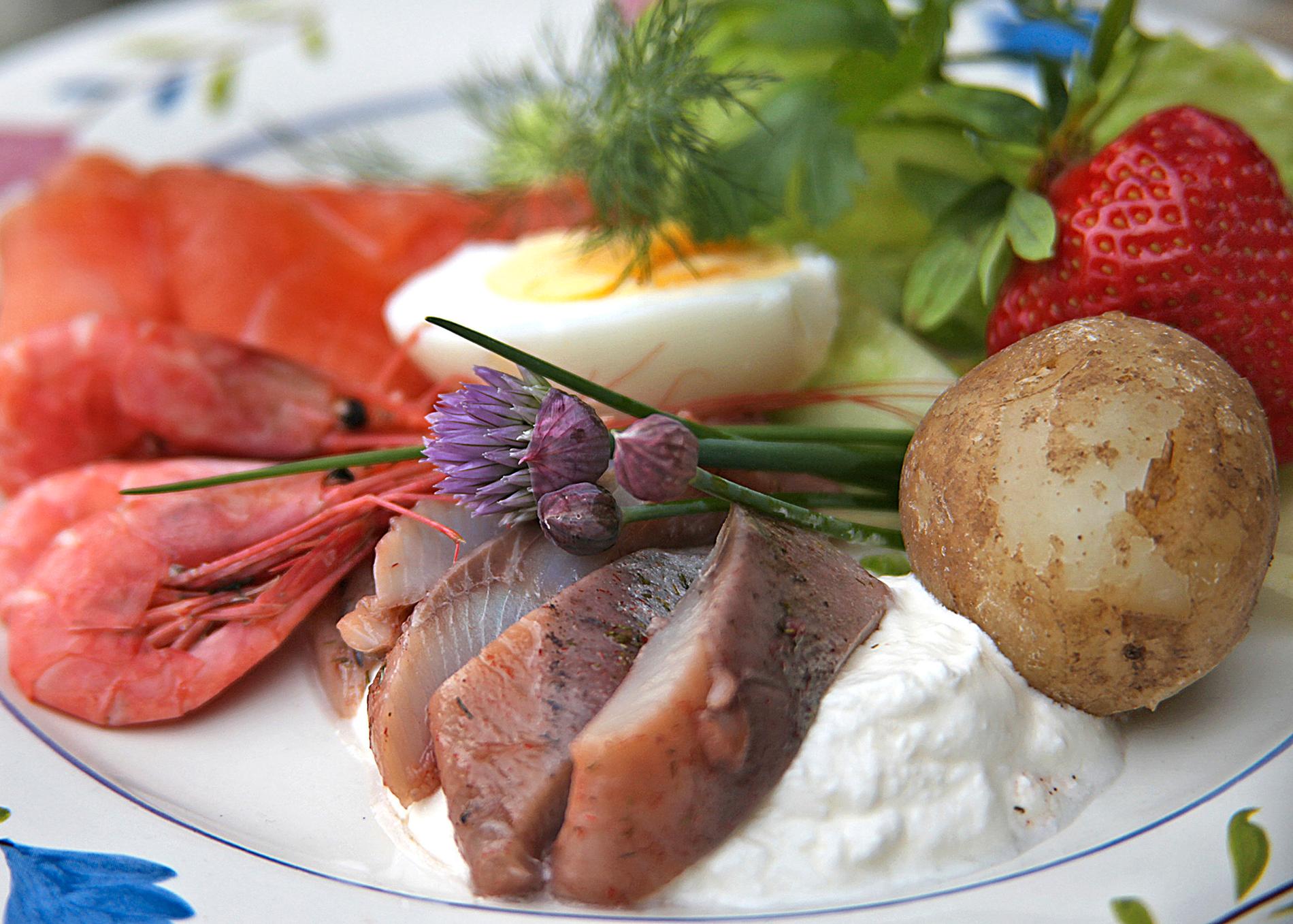 Klassisk midsommarmat är matjessill, gravad lax, räkor och hårdkokt ägg serverat med nykokt färskpotatis.