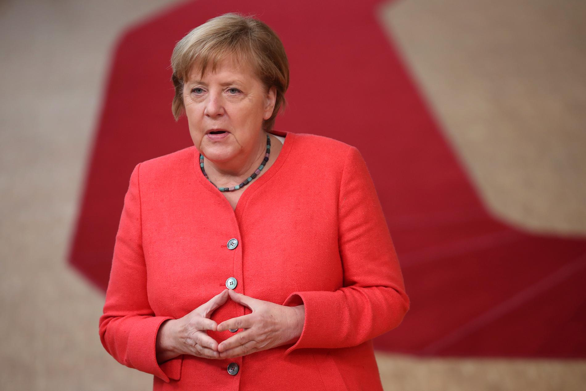 Klassisk Merkelpose med händerna, i Tyskland kallad "Merkel-Raute".