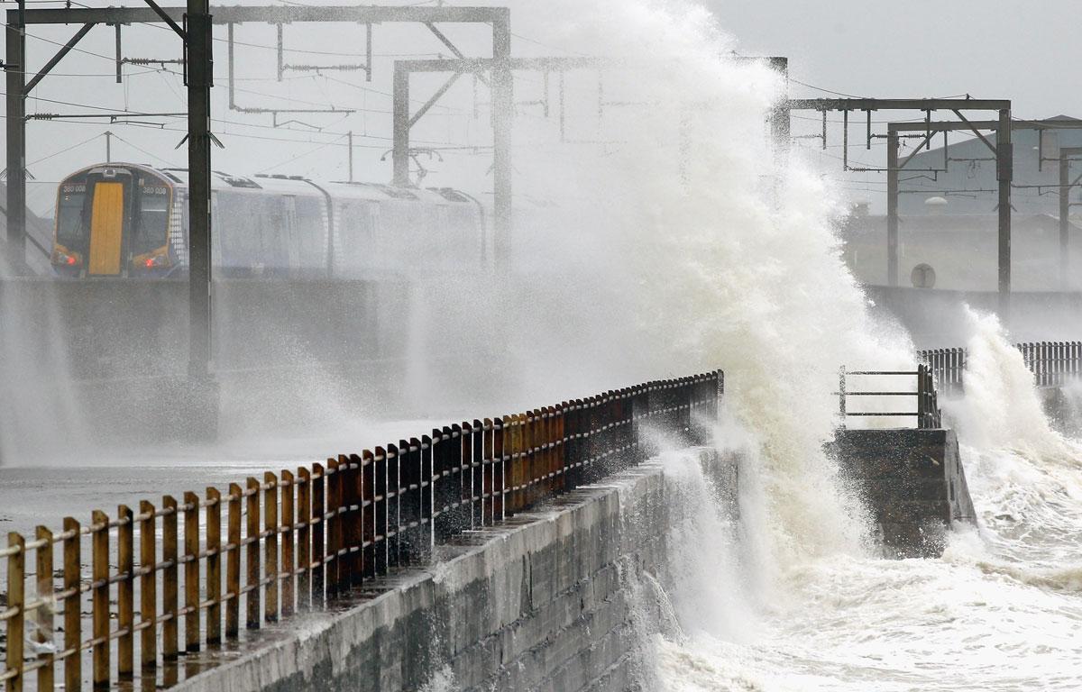 Vågor slår mot en kaj i Skottland. Katia härjar under måndagen för fullt över brittiska öarna.