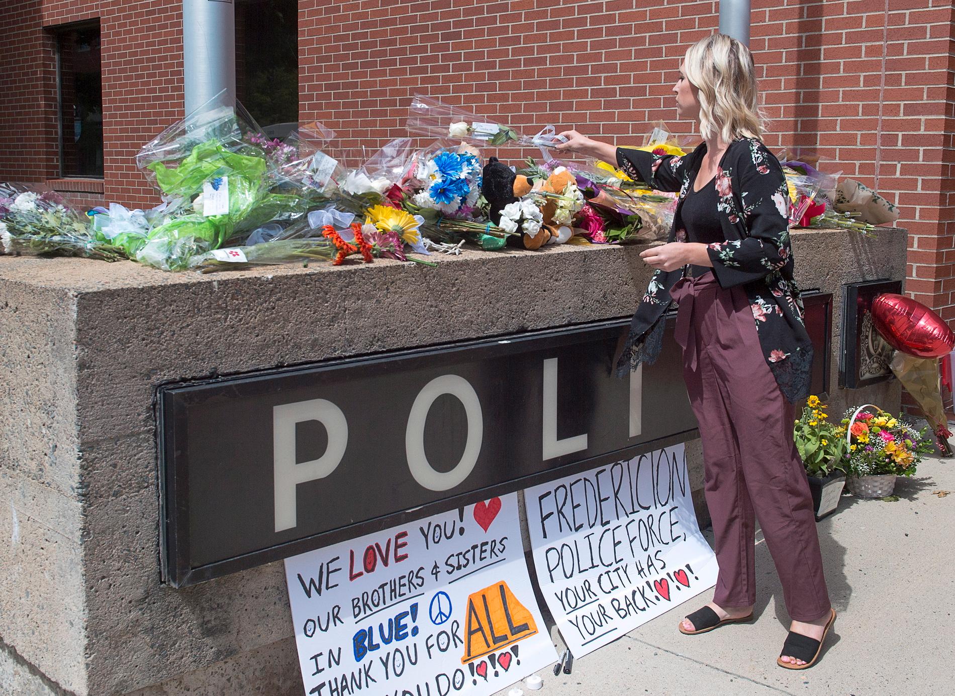 Många lämnar blommor utanför polisstationen i Fredericton.