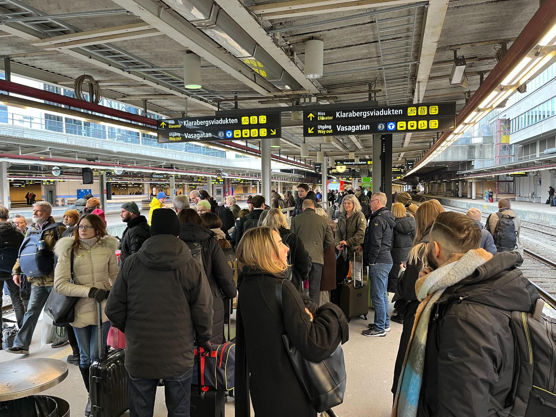 Många resenärer väntar på Stockholms centralstation. 