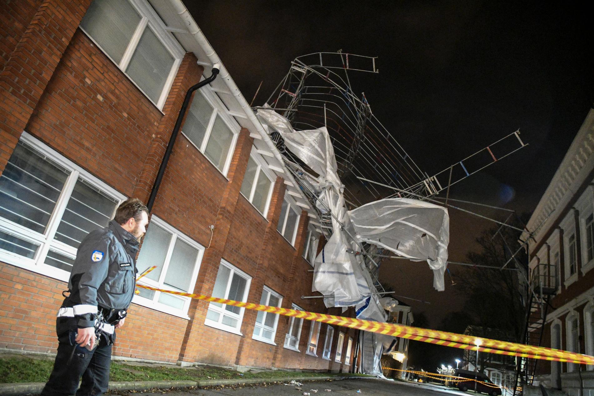 Väktare spärrar av kring en byggnadsställning som lossnat från ett tak på en skola på S:t Lars området i Lund i de kraftiga vindarna på annandagskvällen.
