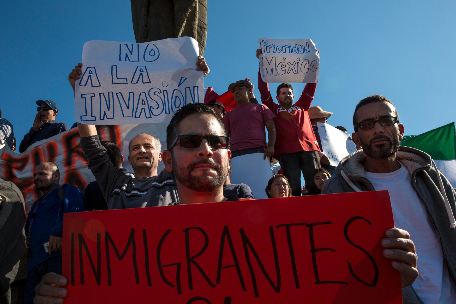 Demonstranter protesterar mot de centralamerikanska migranterna, vars karavan nu har nått till Tijuana i Mexiko.
