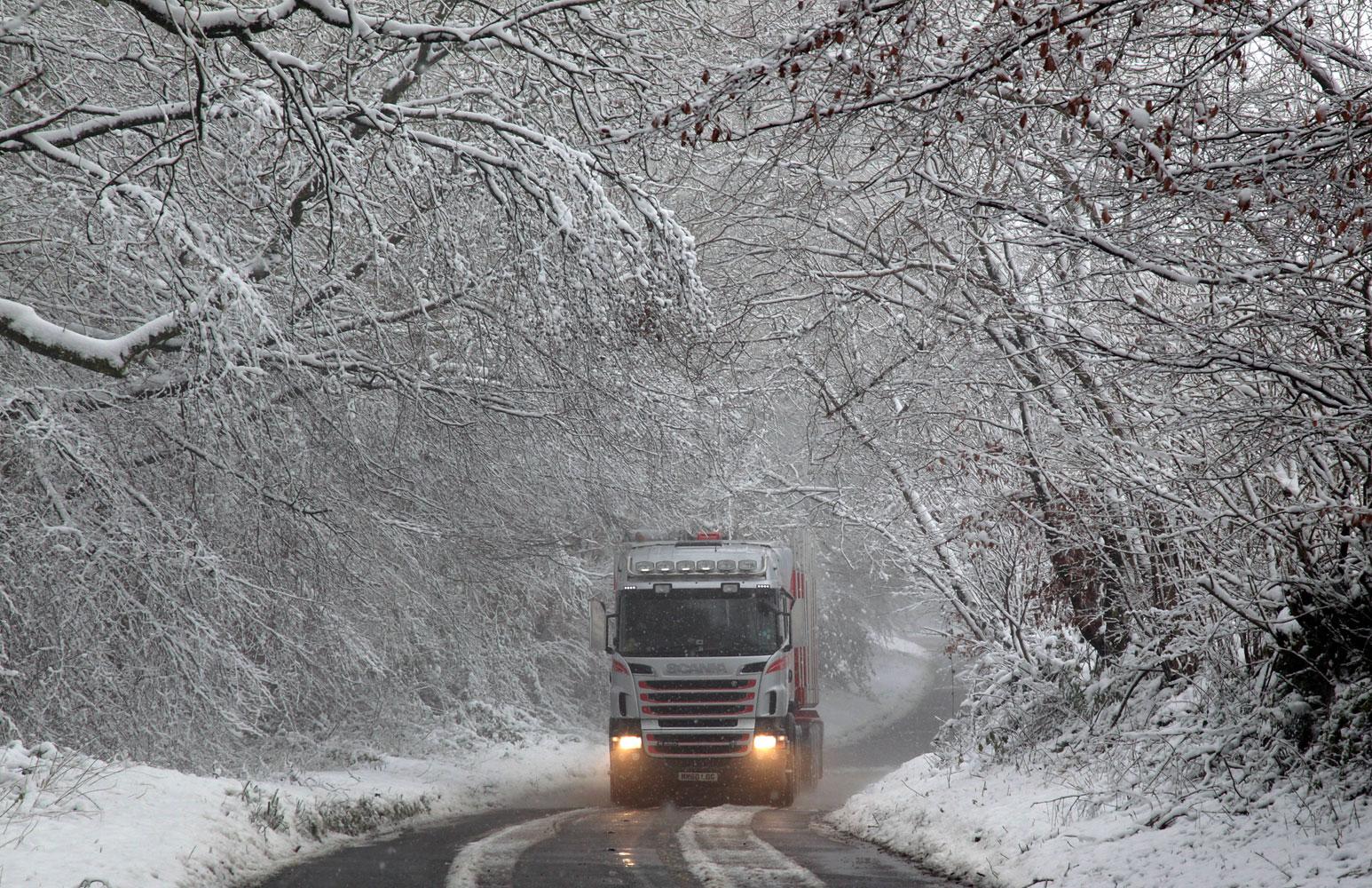 En lastbil kör i snöslasket i Dulverton, England.