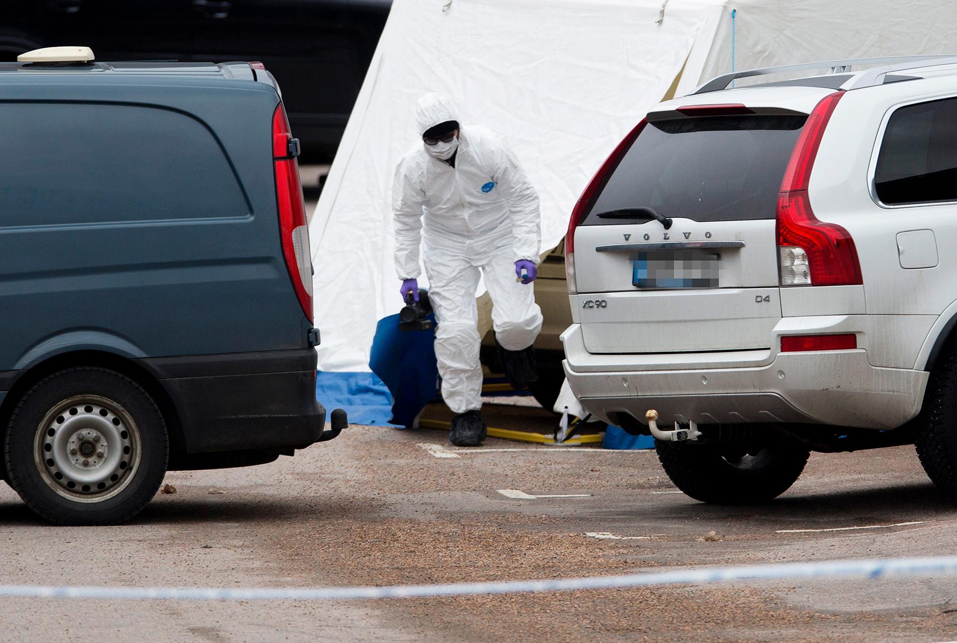 Polisens tekniker arbetar på platsen i närheten av Uddevalla sjukhus där tre mördade personer hittades på lördagsmorgonen.