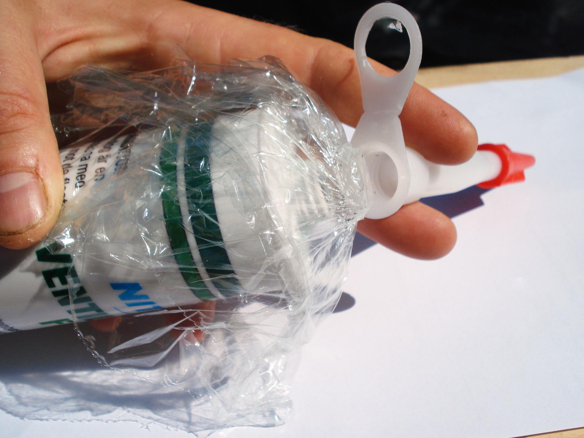 Tipset med plastfolie runt öppningen av en silikontub