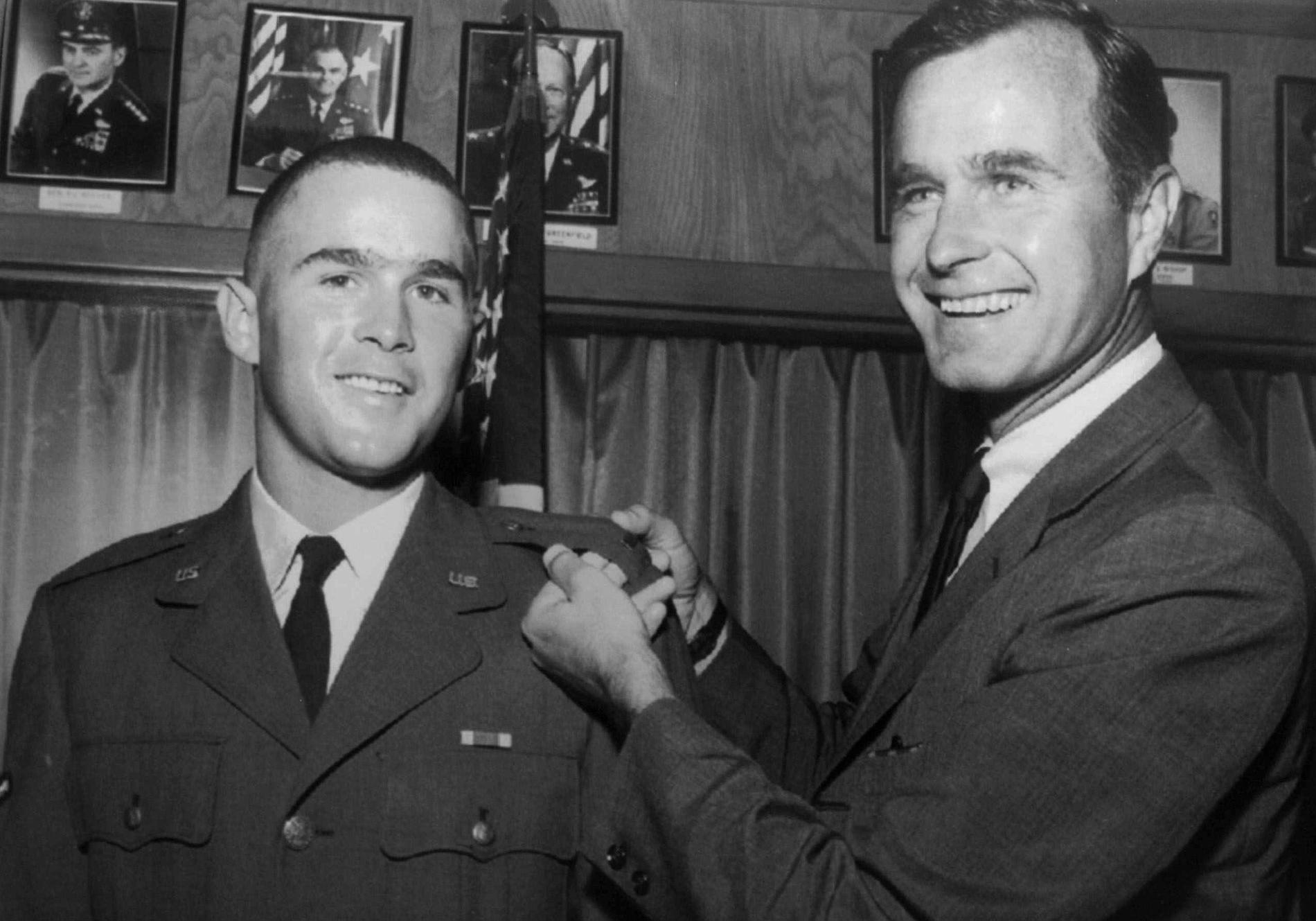 n this 1968 file photo provided by the Texas National Guard, George H.W. Bush, right, is about to pin a lieutenant bar on his son, George W. Bush, after the younger Bush was made an officer in the Texas Air National Guard in Ellington Field, Texas. Bush died at the age of 94 on Friday, Nov. 30, 2018, about eight months after the death of his wife, Barbara Bush.