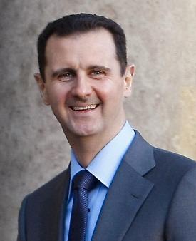 Den leende diktatorn Bashar al-Assad.