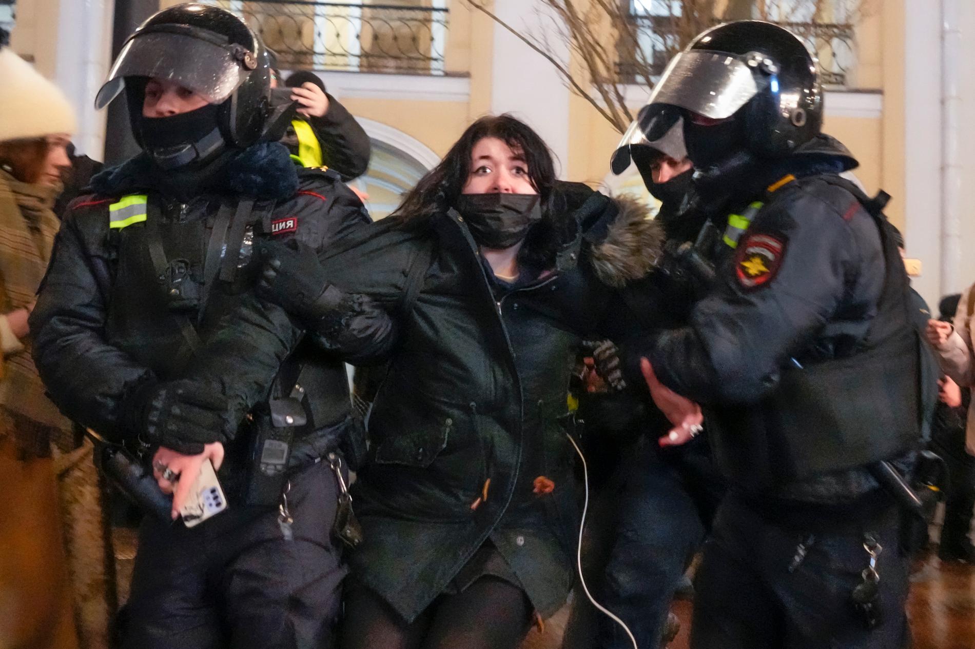 En kvinna som demonstrerar mot kriget i Ukraina tas omhand av polis i St Petersburg på fredagskvällen. 