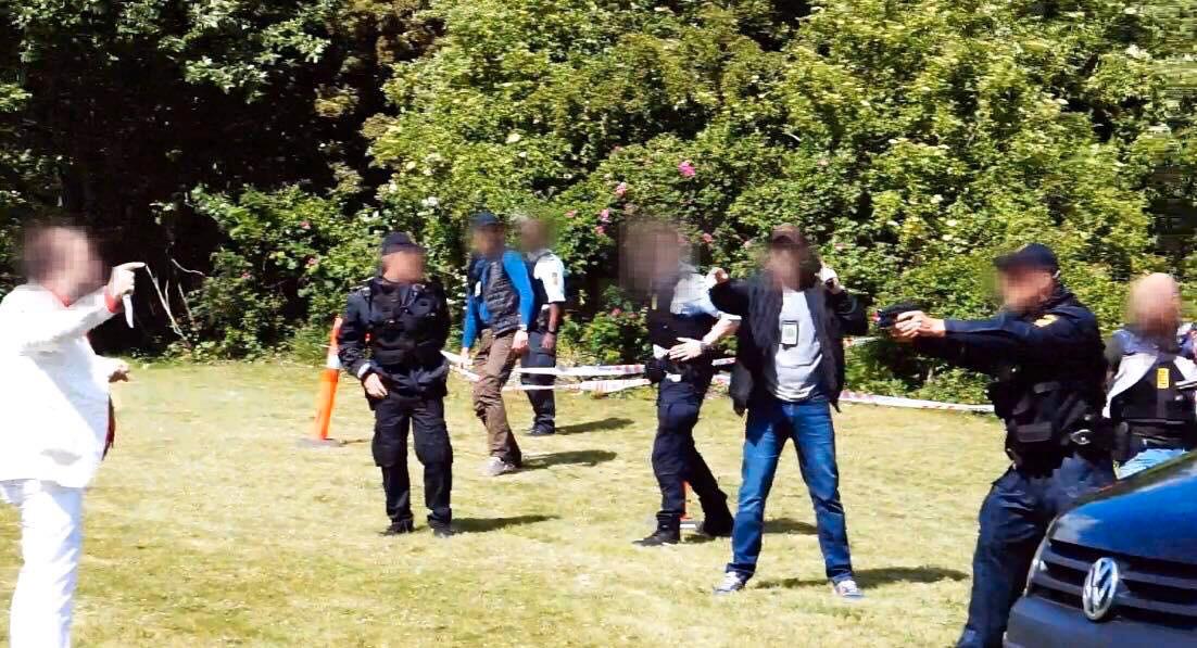 Bilder från platsen visar hur polisen riktar vapen mot den knivbeväpnade mannen. 