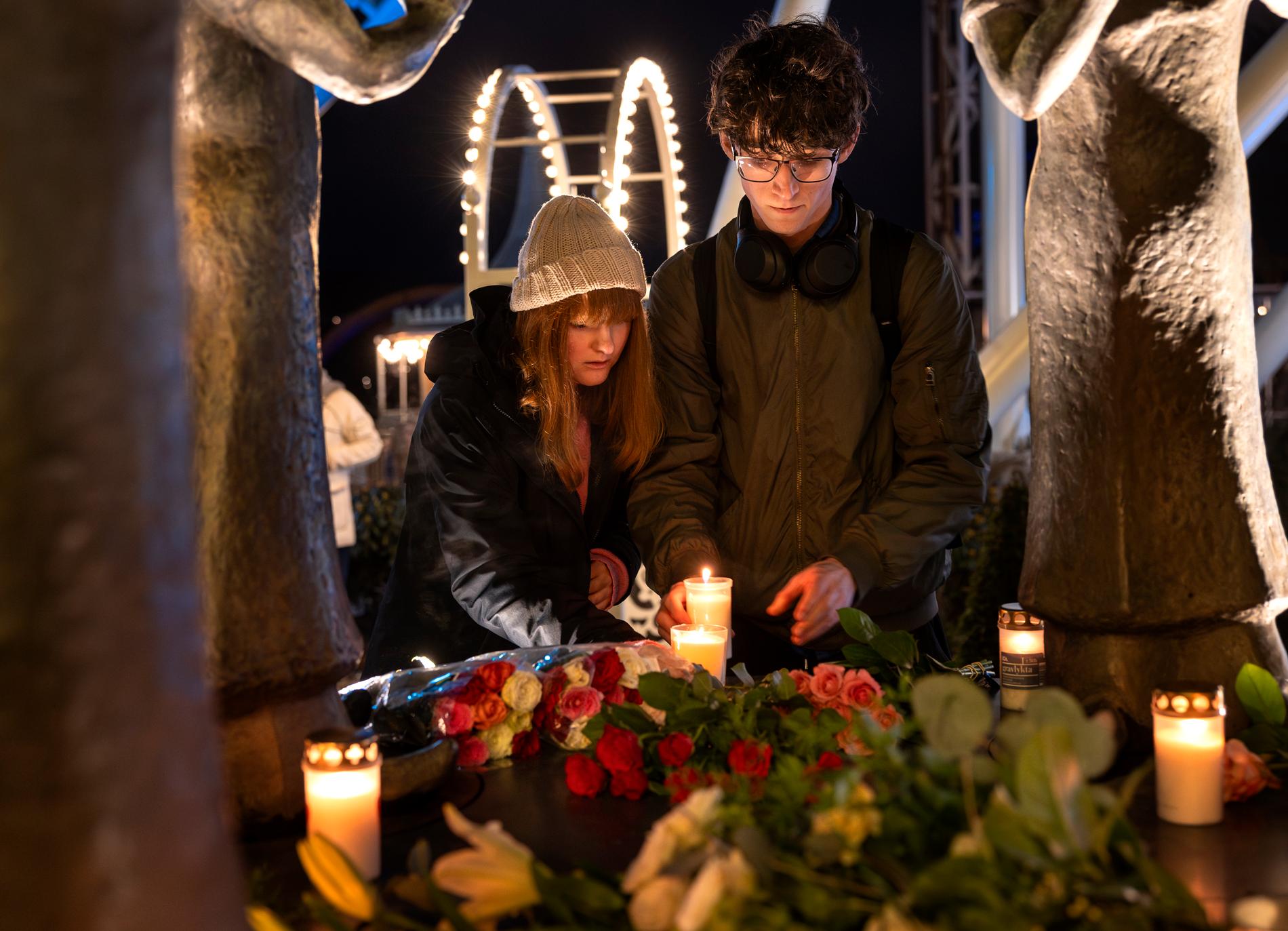 Abigail Salt och Alexander Gustafsson tänder ljus vid minnestunden på Liseberg. 