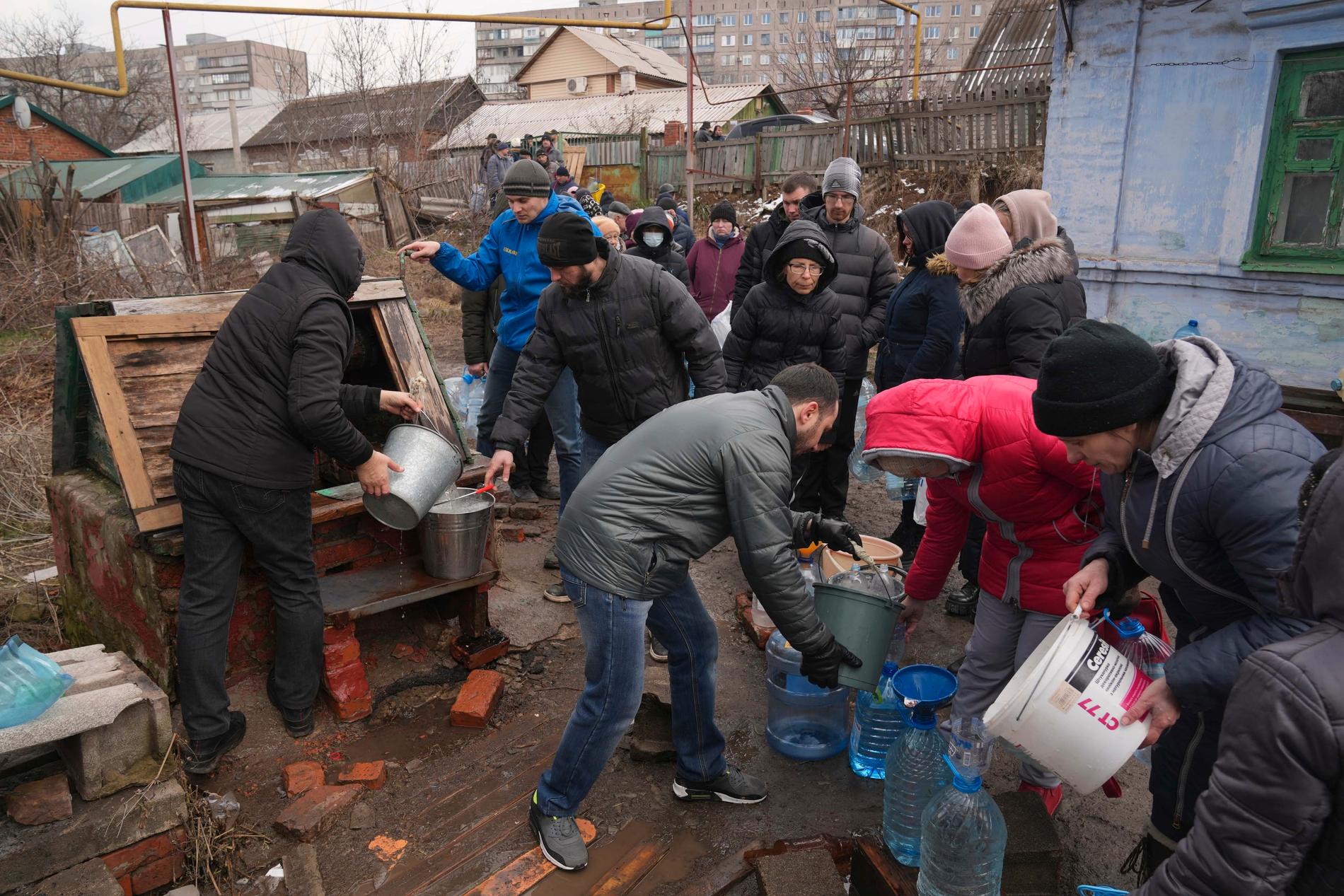 Människor i Mariupol köar för vatten i utkanten av staden. Bild från 9 mars. 