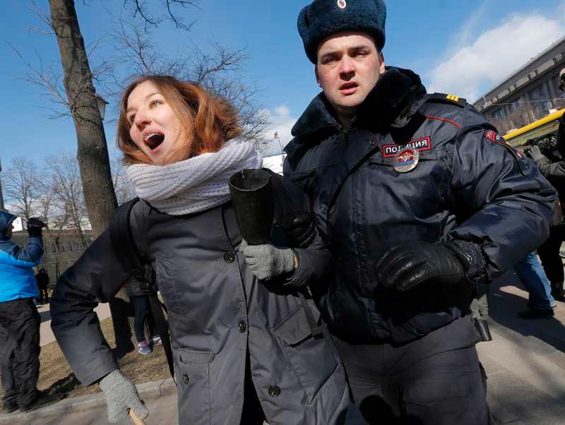 En polis griper en vänsteraktivist utanför konferensen i Sankt Petersburg där högerextrema partier från 15 länder samlats.