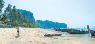 Vid Ao Nangs strand i Krabi väntar de traditonella långsvansbåtarna, som inte är något för rörelsehindrade. Här får du vada ut med skorna i näven för att komma ombord.