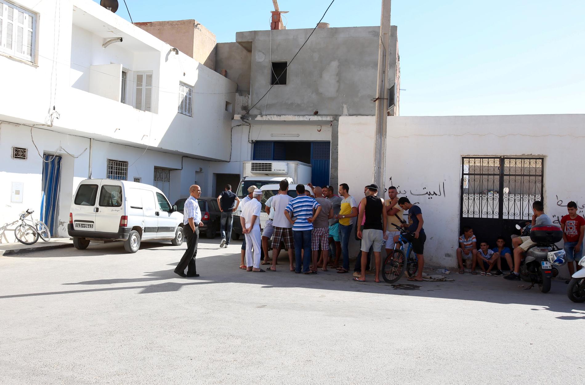 Människor samlas utanför familjens hus i Msaken, tolv mil söder om Tunisiens huvudstad Tunis.