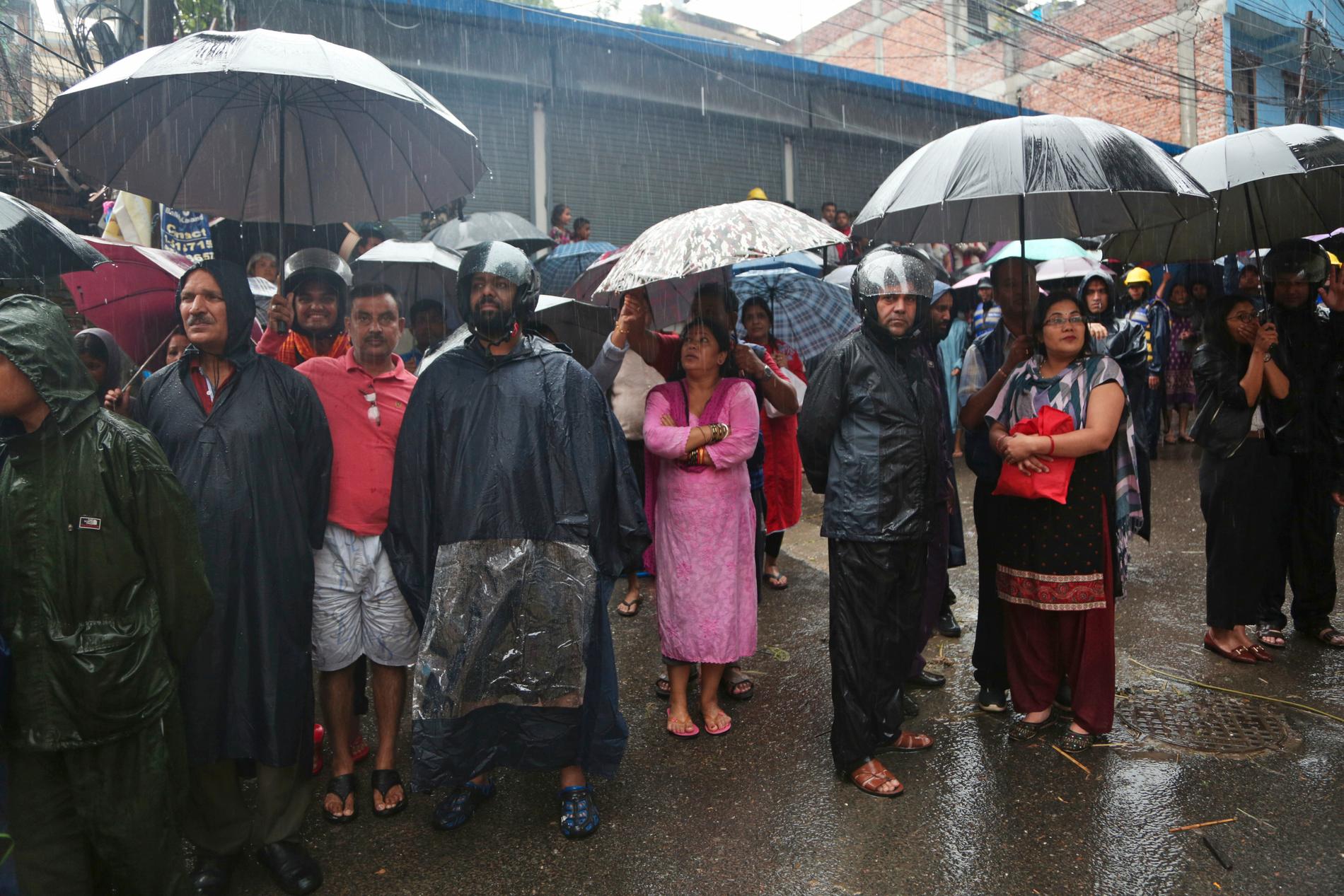 I Katmandu i Nepal tittar människor på när soldater räddar personer från deras översvämmade bostäder.