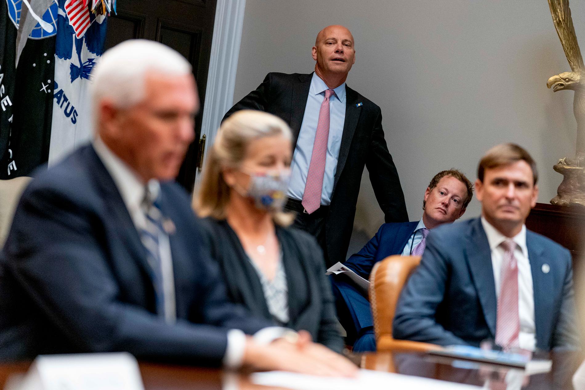 Vicepresident Mike Pence stabschef, i rosa slips i bakgrunden.