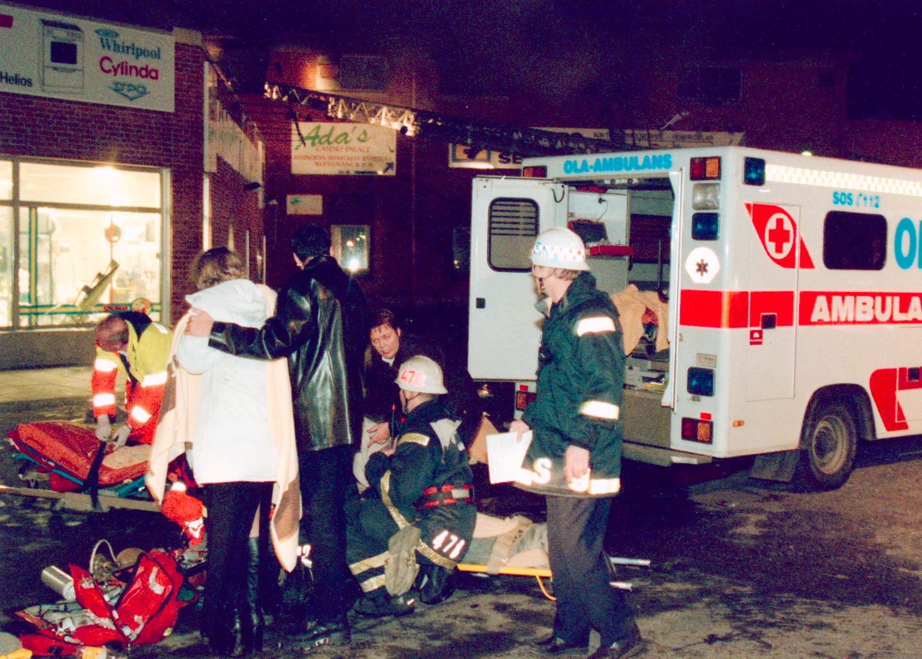 En ambulans utanför festlokalen. Totalt dog 63 ungdomar i branden och över 200 skadades. 