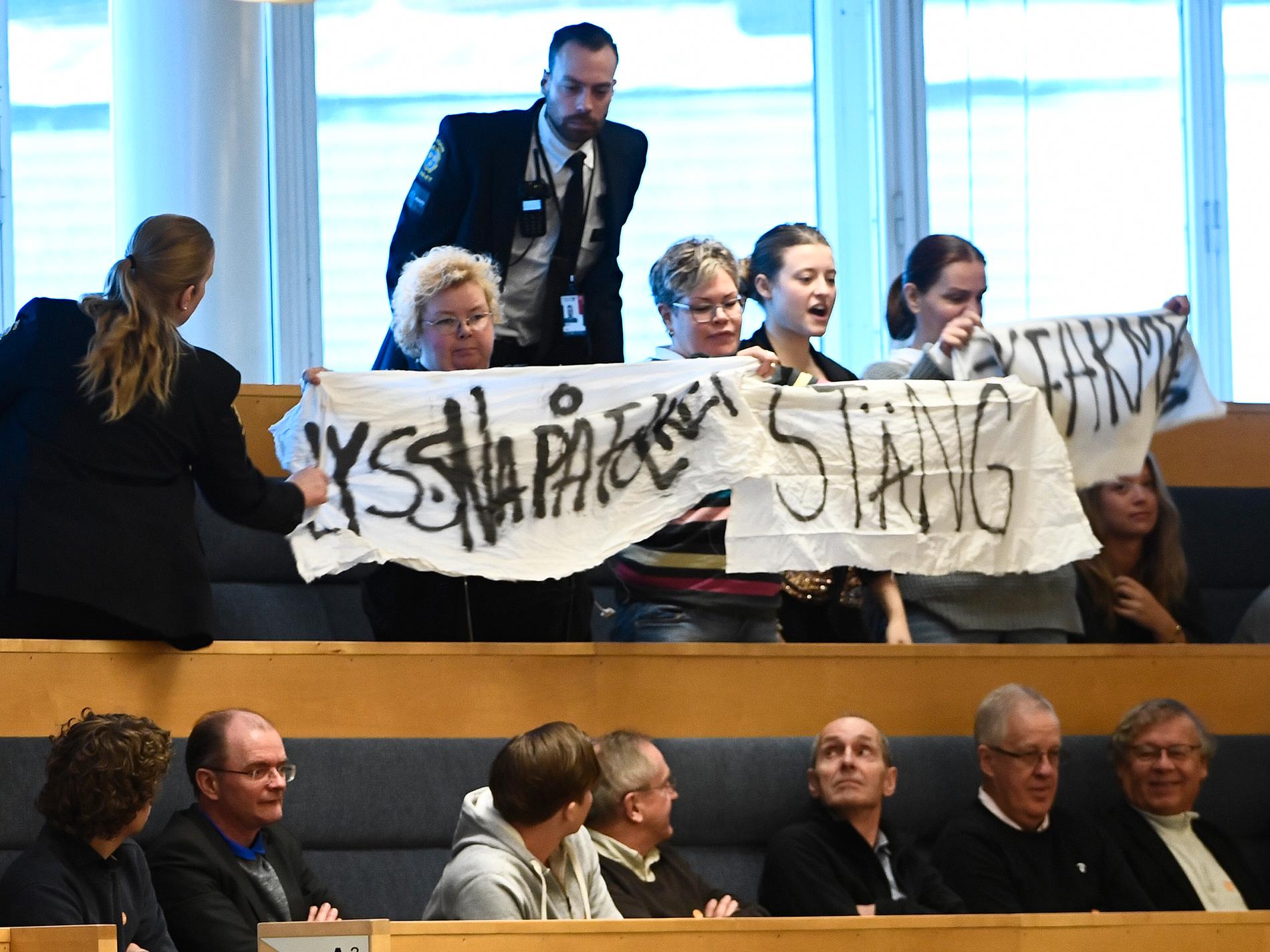 Protest på åhörarläktaren under partiledardebatt i riksdagen i Stockholm.