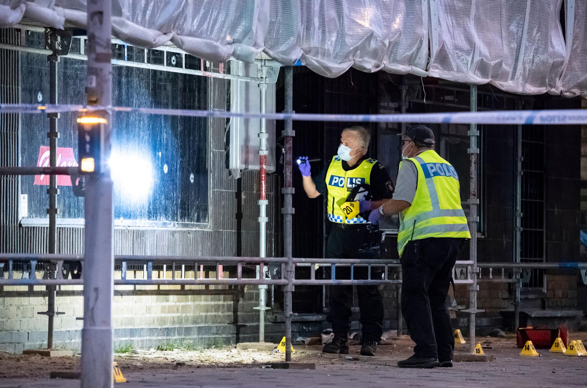 Polisens kriminaltekniker arbetade intensivt på Drottninggatan i Malmö efter att sex personer skjutits på öppen gata i anslutning till ett internetcafé i juni.
