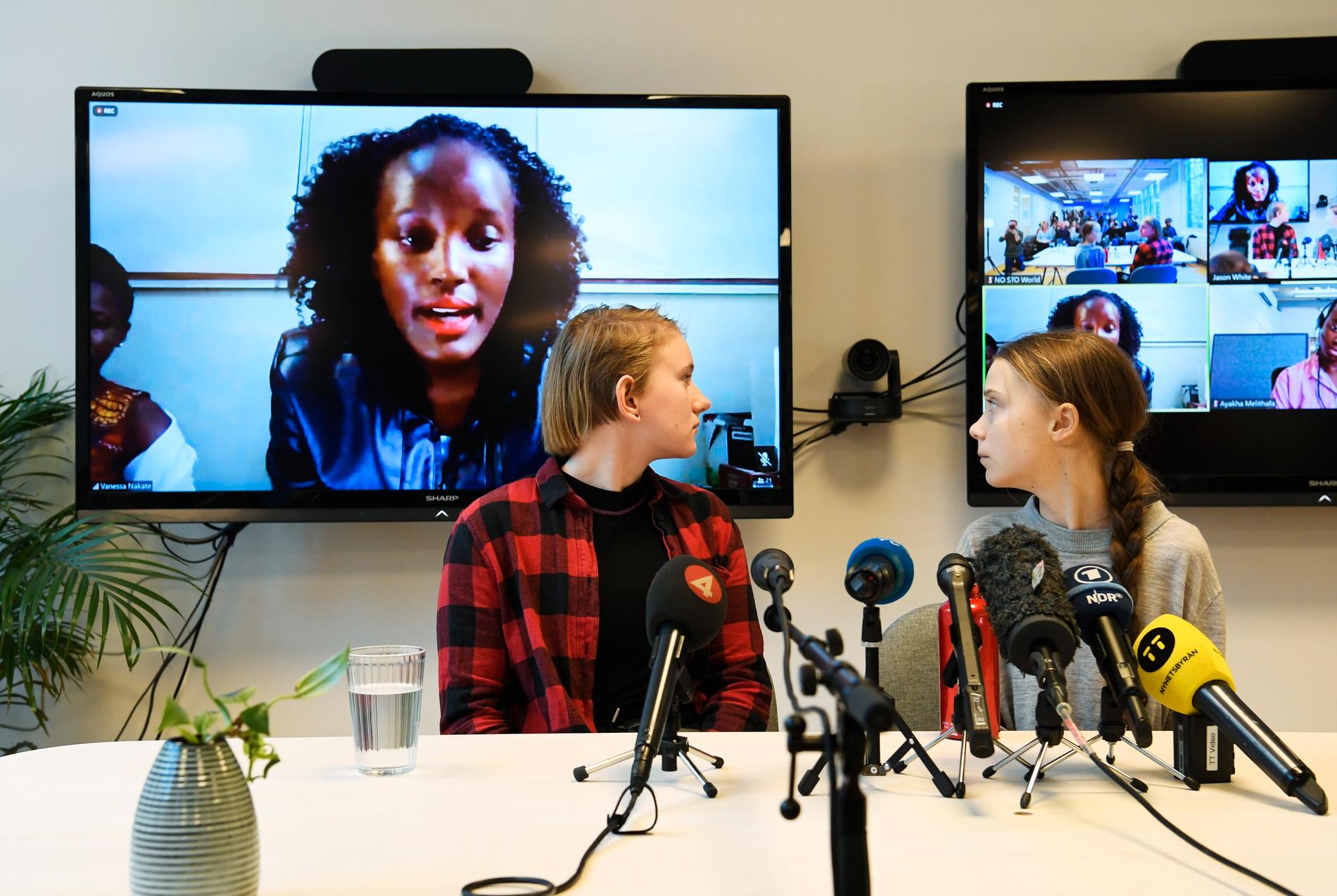 Klimataktivisterna Ell Ottosson Jarl och Greta Thunberg under fredagens presskonferens i Stockholm. Vanessa Nakate från Uganda var en av flera afrikanska klimataktivister som deltog via videolänk.