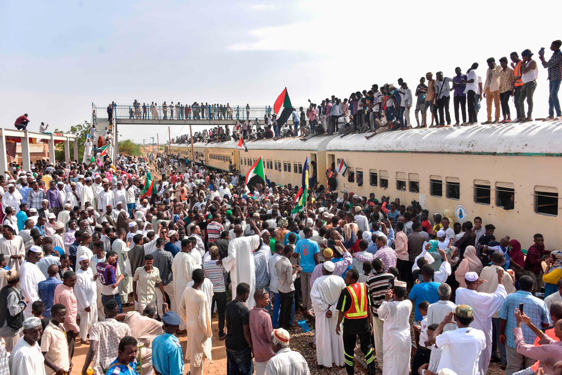 Medlemmar ur proteströrelsen från staden Atbara anländer med tåg till Baharistationen i Khartum för att fira lördagens ceremoni, som för med sig hopp om demokratiskt styre i Sudan.