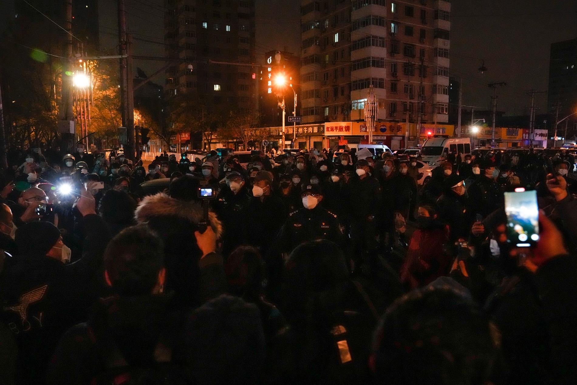 Polis och demonstranter i Peking under söndagen.