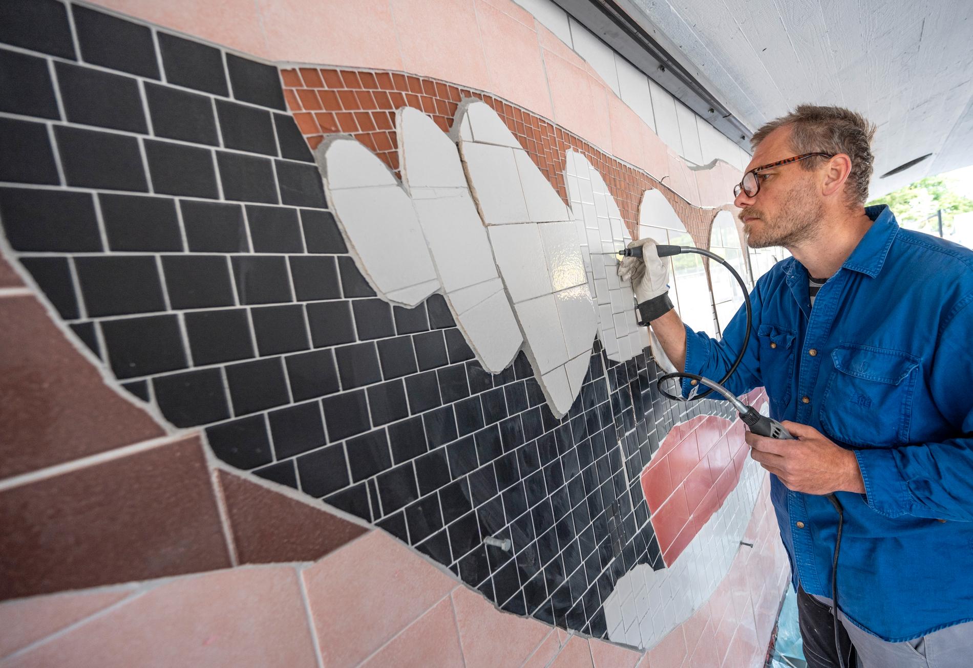Zlatans leende fixas till och får skottsäkert glas. Konstnären Björn Carnemalm fixar fogarna på konstverket i gångtunneln under tågstationen på Rosengård i Malmö.