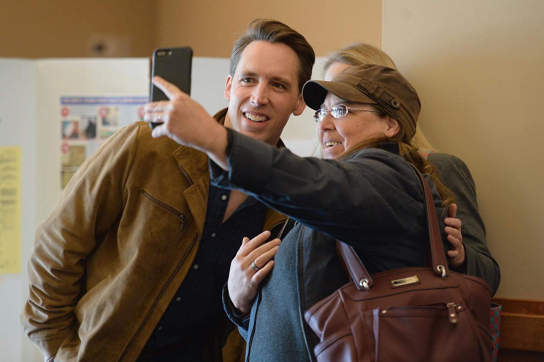 Josh Hawley (R), kandidat till senaten för Missouri tar en selfie ihop min fru och en väljare i valloken i en vallokal i Columbia, Missouri. 