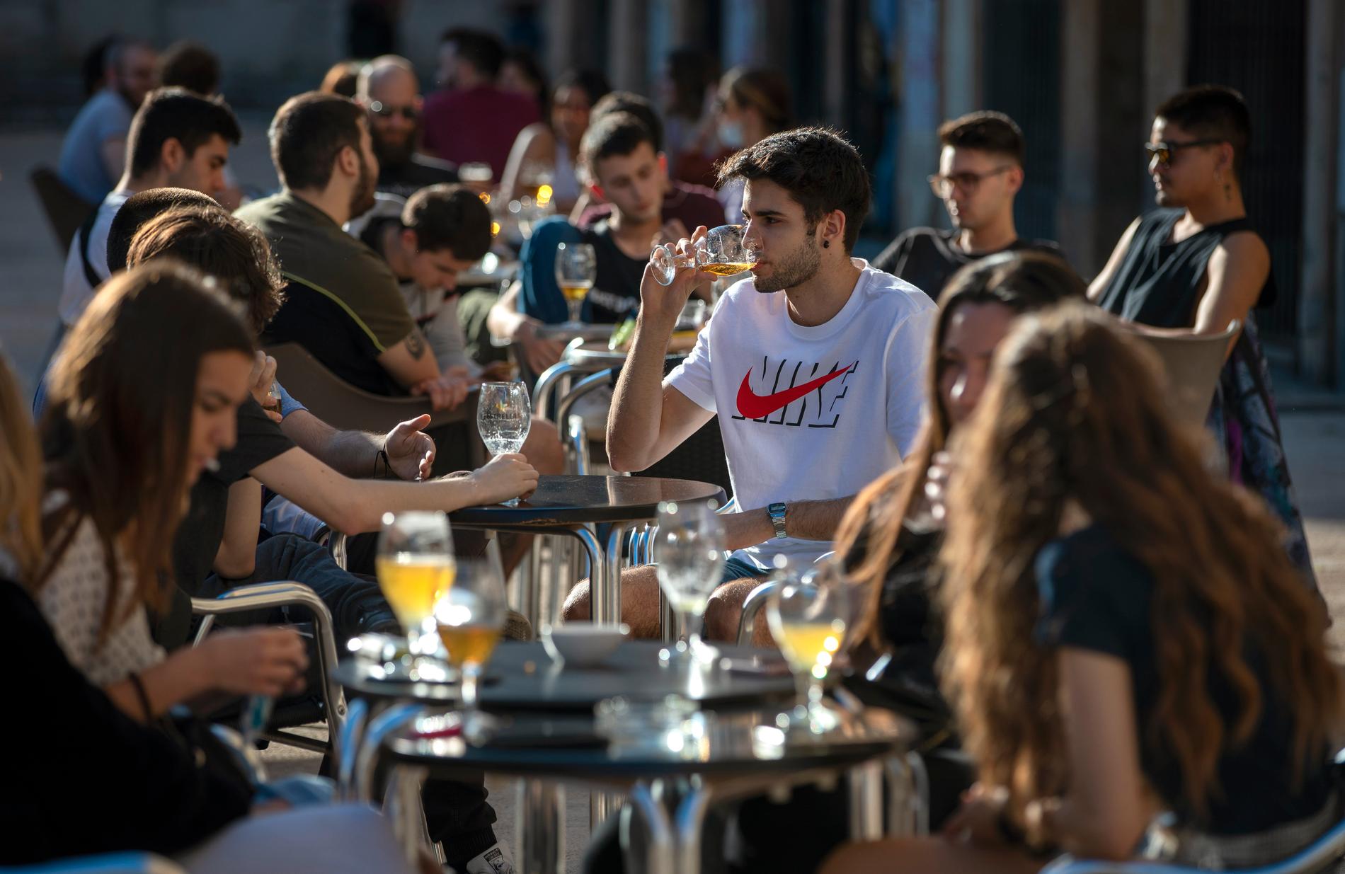 Mingelsugna invånare i Tarragona njuter av sällskap och dryck på en uteservering, sedan Spanien lyft de strängaste restriktionerna för runt hälften av landets cirka 47 miljoner invånare.