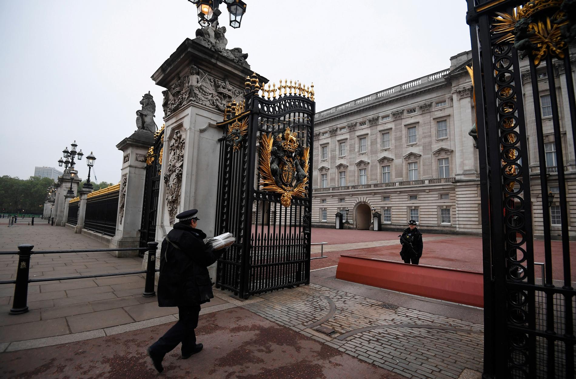 En polisman levererar morgontidningar till Buckingham Palace.