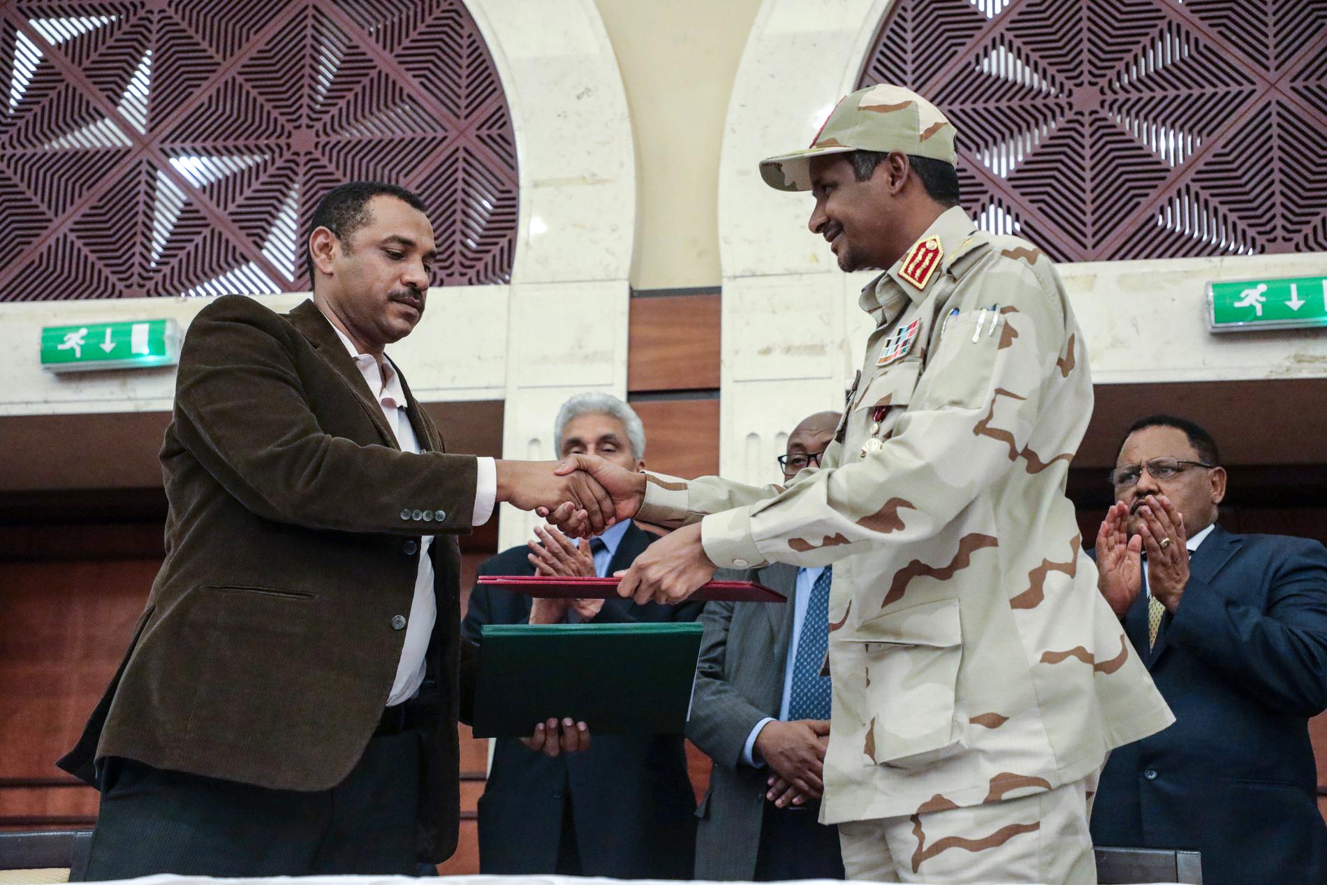 Mohamed Hamdan Dagalo skakar hand med Ahmad al-Rabi, en av oppositionsledarna.