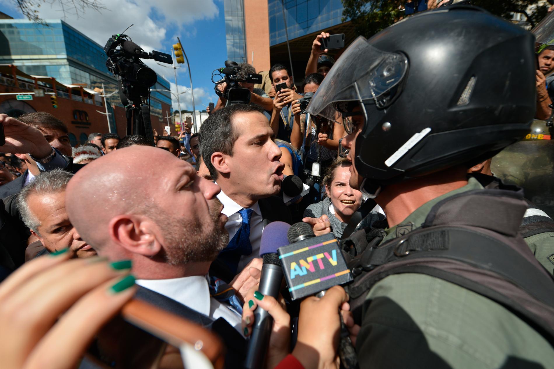 Oppositionsledaren Juan Guaidó diskuterar med soldater från nationalgardet som hindrar honom från att komma in i parlamentet i Venezuela på tisdagen.