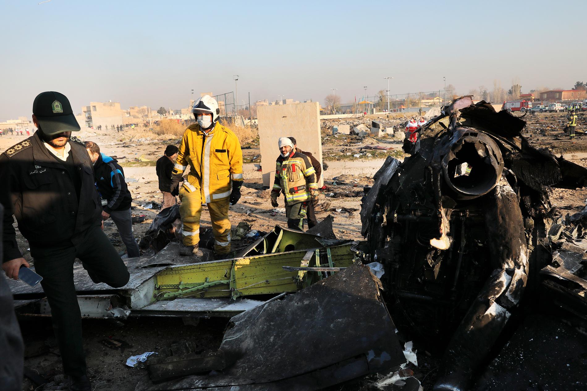 Räddningsmanskap arbetar bland vrakdelarna från det ukrainska flygplan som kraschade utanför Irans huvudstad Teheran.