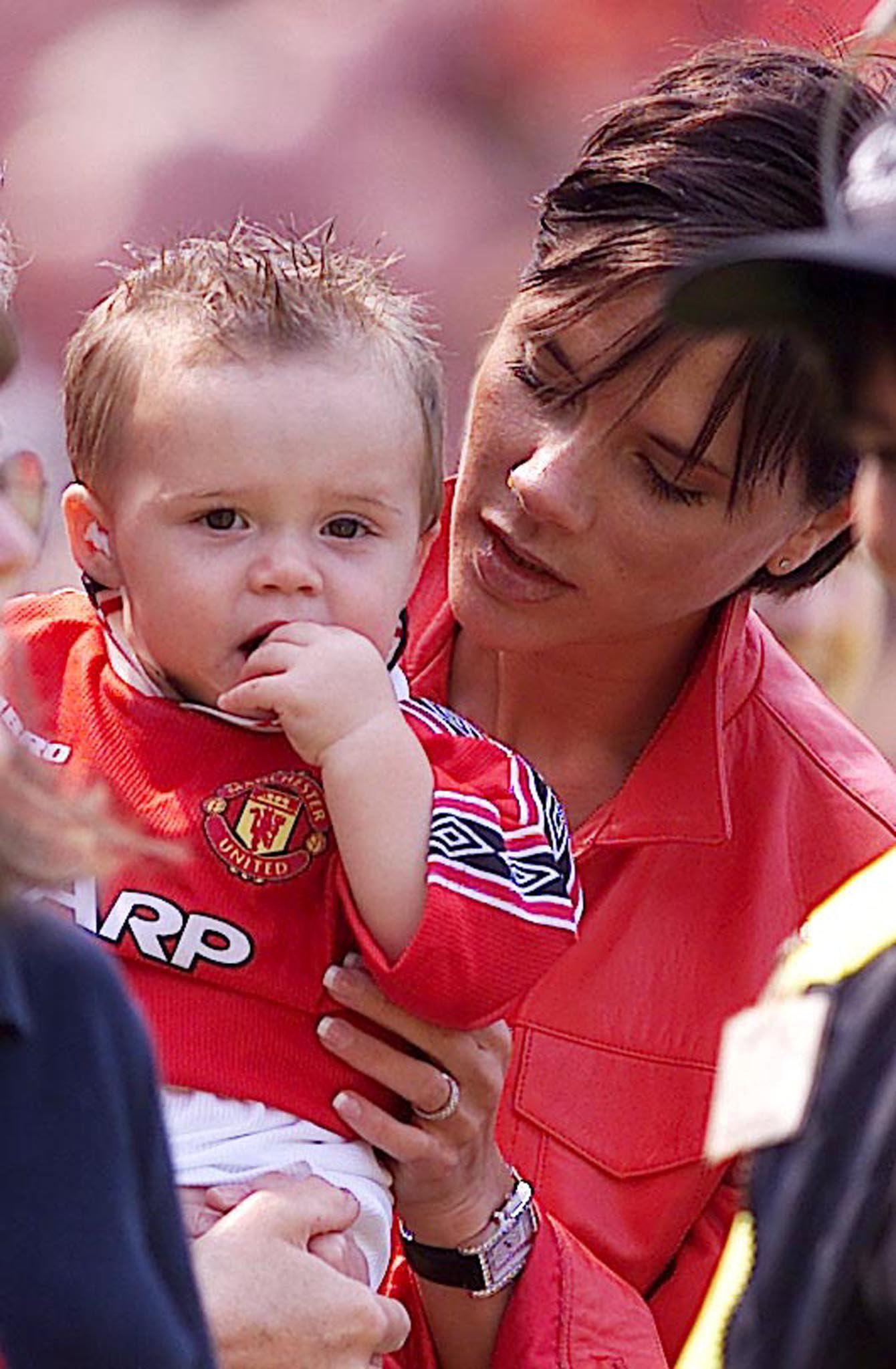 2000 Victoria och Brooklyn hejar på pappa David under en av Manchester Uniteds matcher.